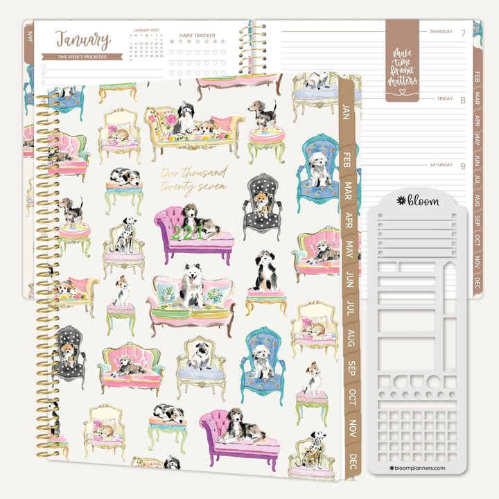 A spiral-bound planner shown open to a decorated cover featuring illustrated dogs sitting in colorful vintage chairs and sofas. The right side shows weekly tabs and a white plastic page divider, all on a clean white background.