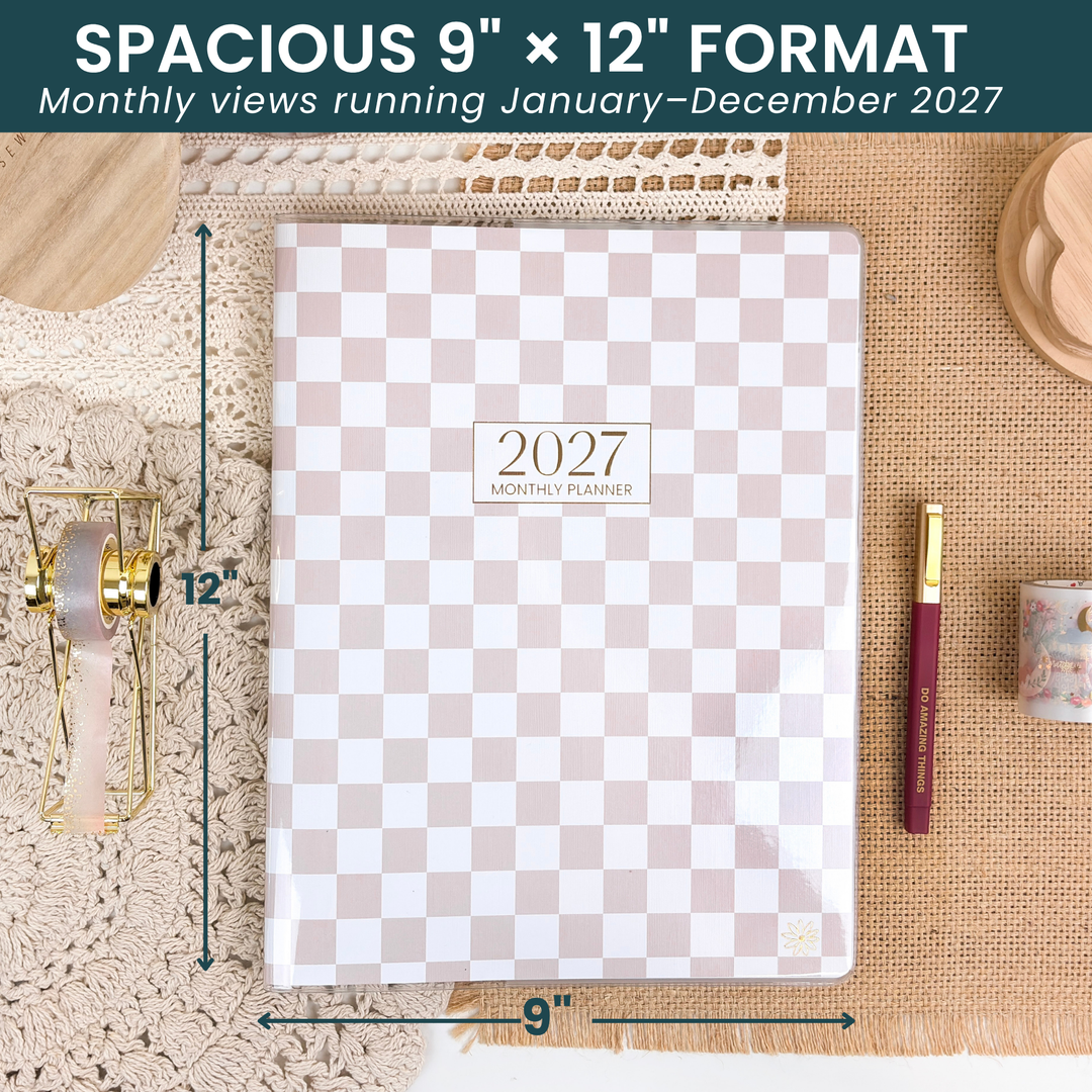 9"  x 12" checkered monthly planner on a desk with arrows showing the size. 