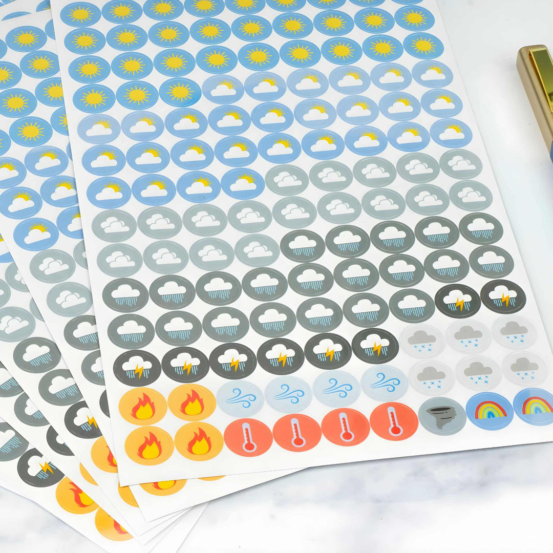 Sheets of weather-themed stickers on a white surface