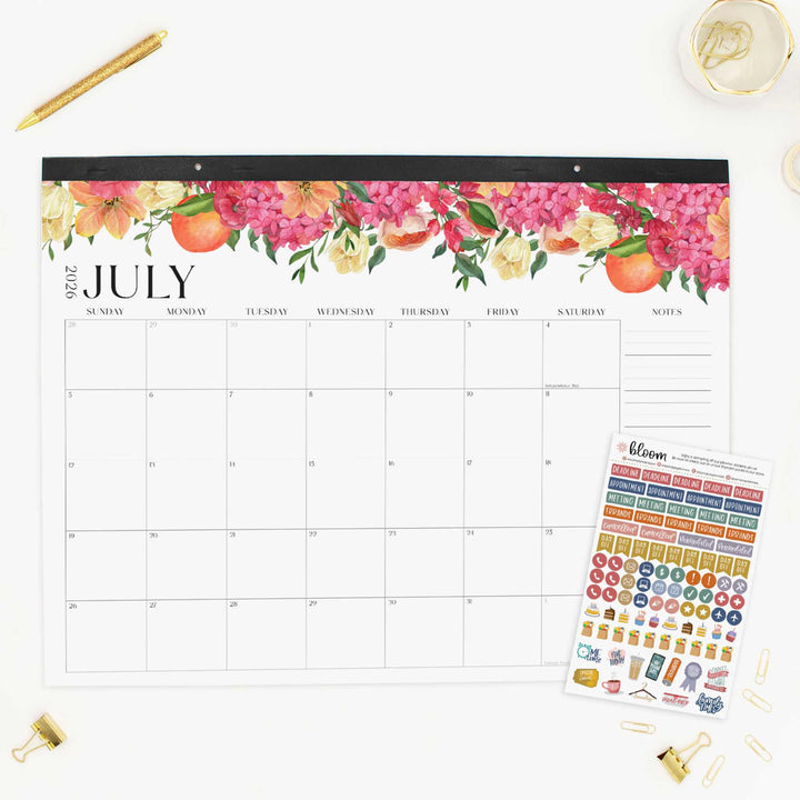 Floral July calendar with decorative stickers on a white surface