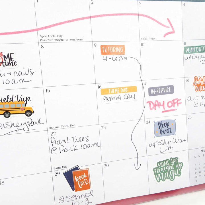 Calendar with colorful stickers and notes on a white background