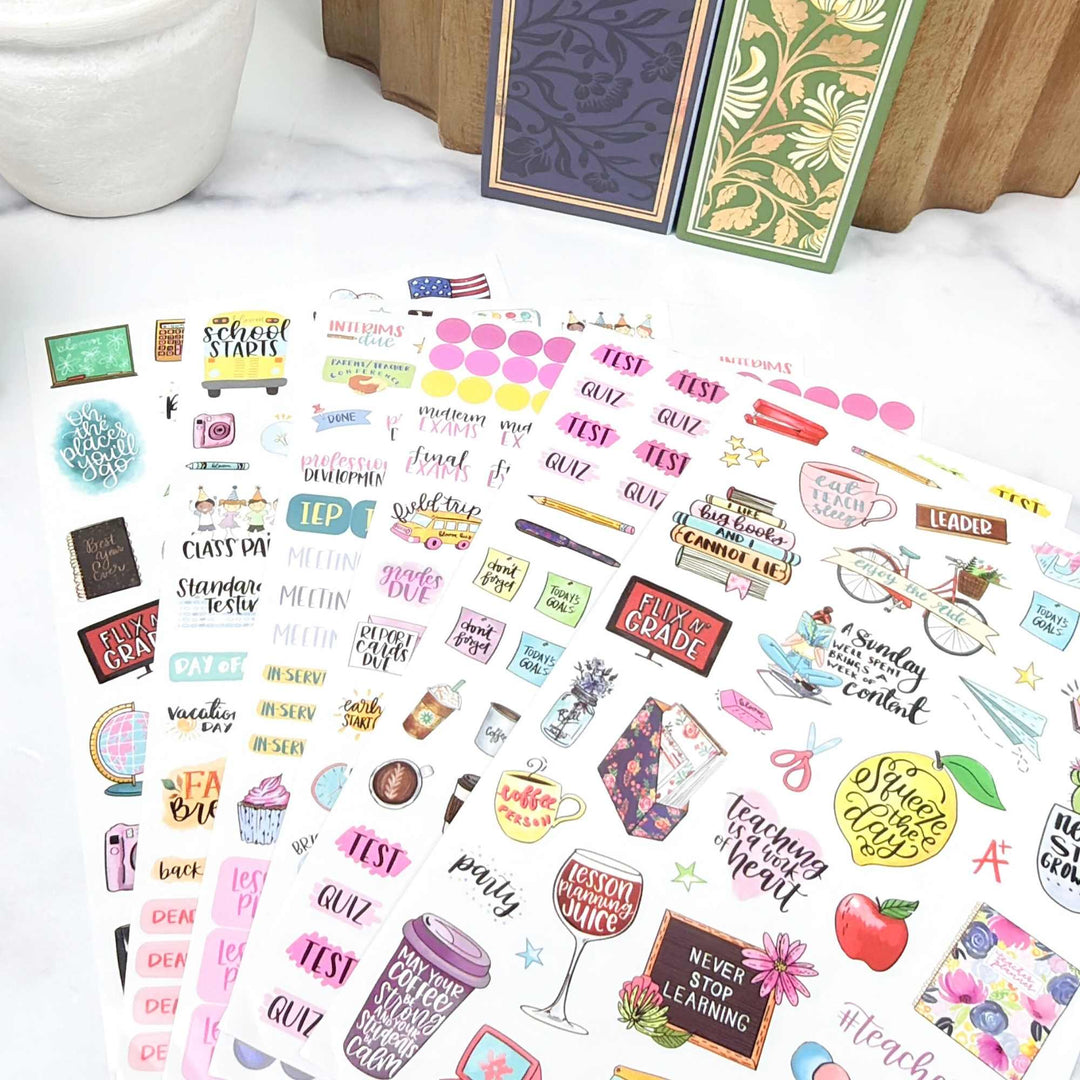 hand-drawn teacher themed planner stickers fanned out on a desk.