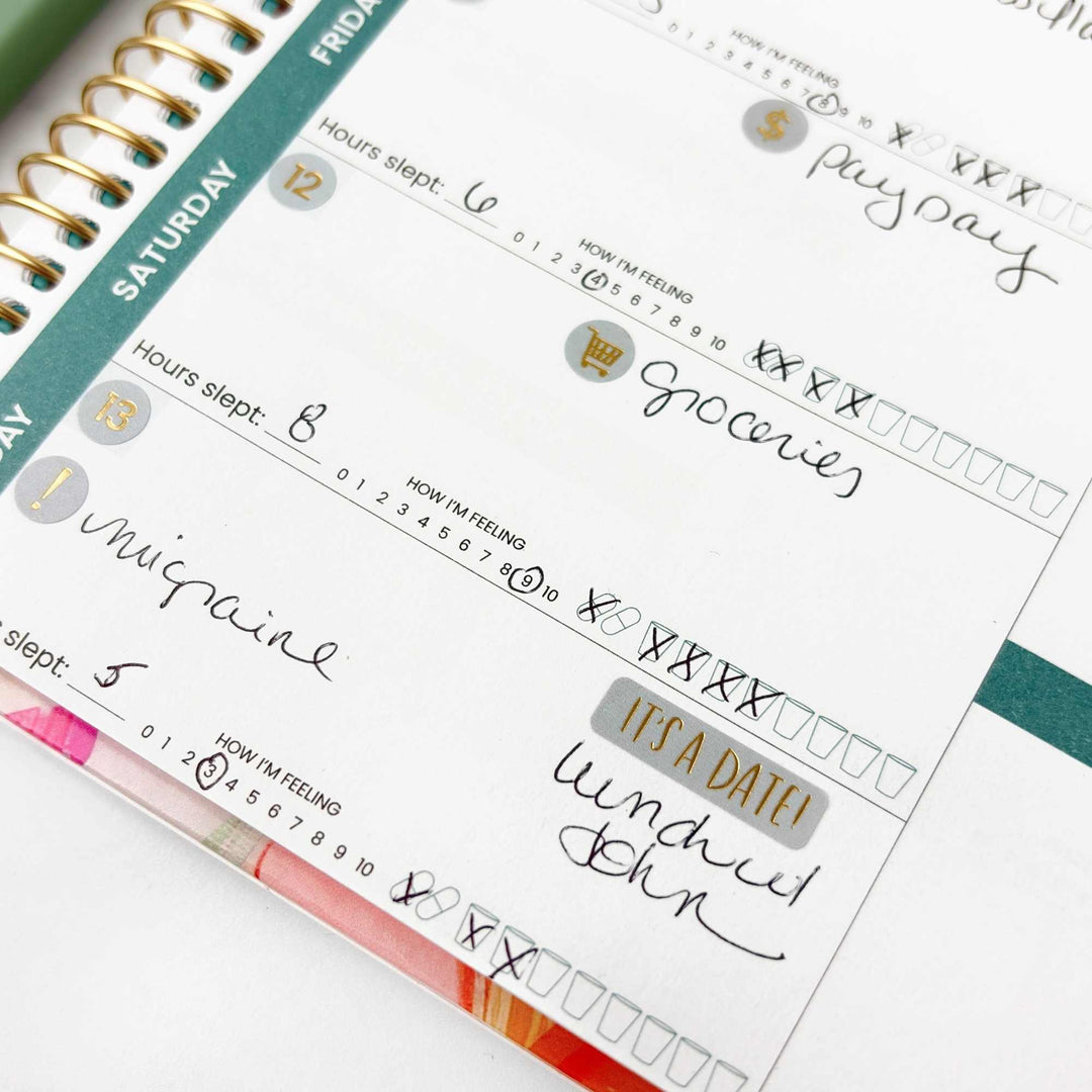 Close-up of a planner with handwritten notes and colorful accents