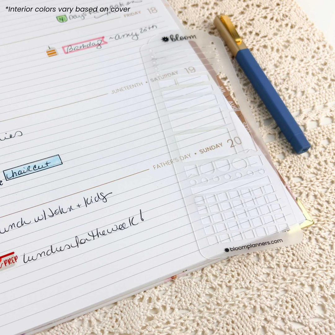 A close-up of a weekly planner page from a Bloom planner, showing handwritten notes, a clear plastic calendar insert, and a blue pen with a gold cap resting on a beige lace doily.