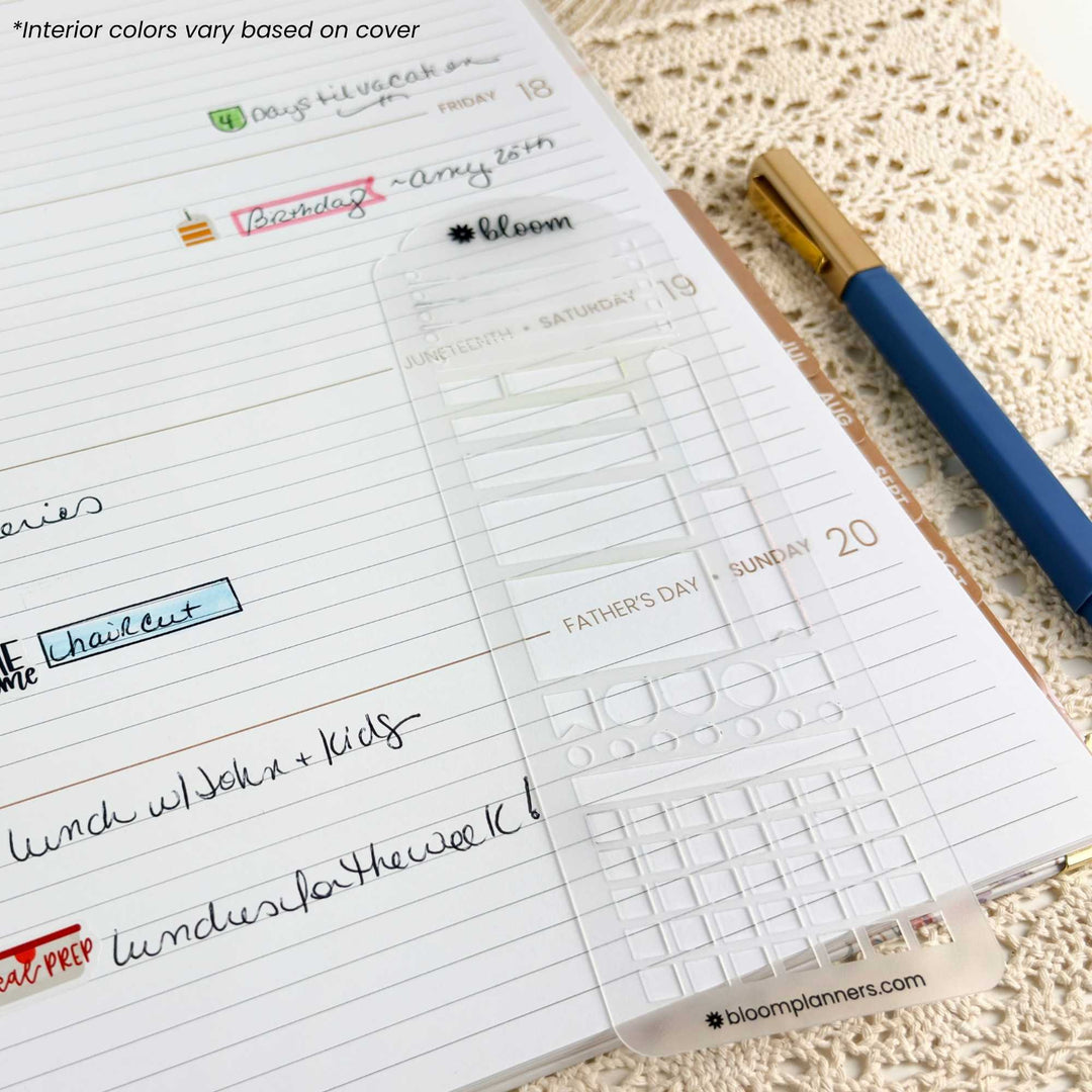 A clear planner sticker sheet with a grid layout and weekday labels, placed on a lined planner page next to a blue pen on a textured cream surface. The sticker sheet has a visible brand mark at the bottom reading bloomplanners.