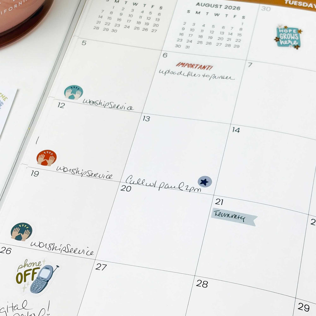 A planner filled out with stickers from this pack including a "phone off" sticker. 