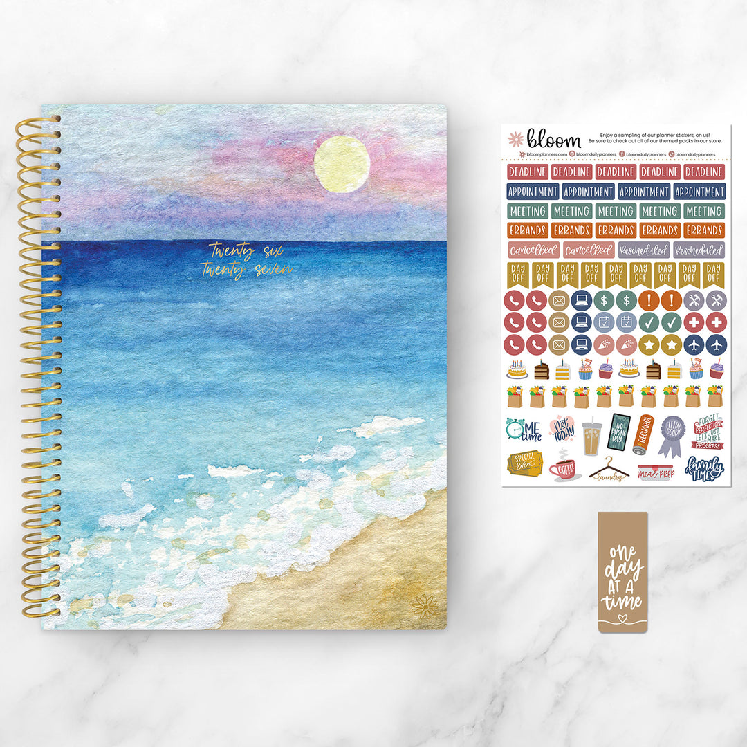 Planner with beach cover and sticker sheet on a white background