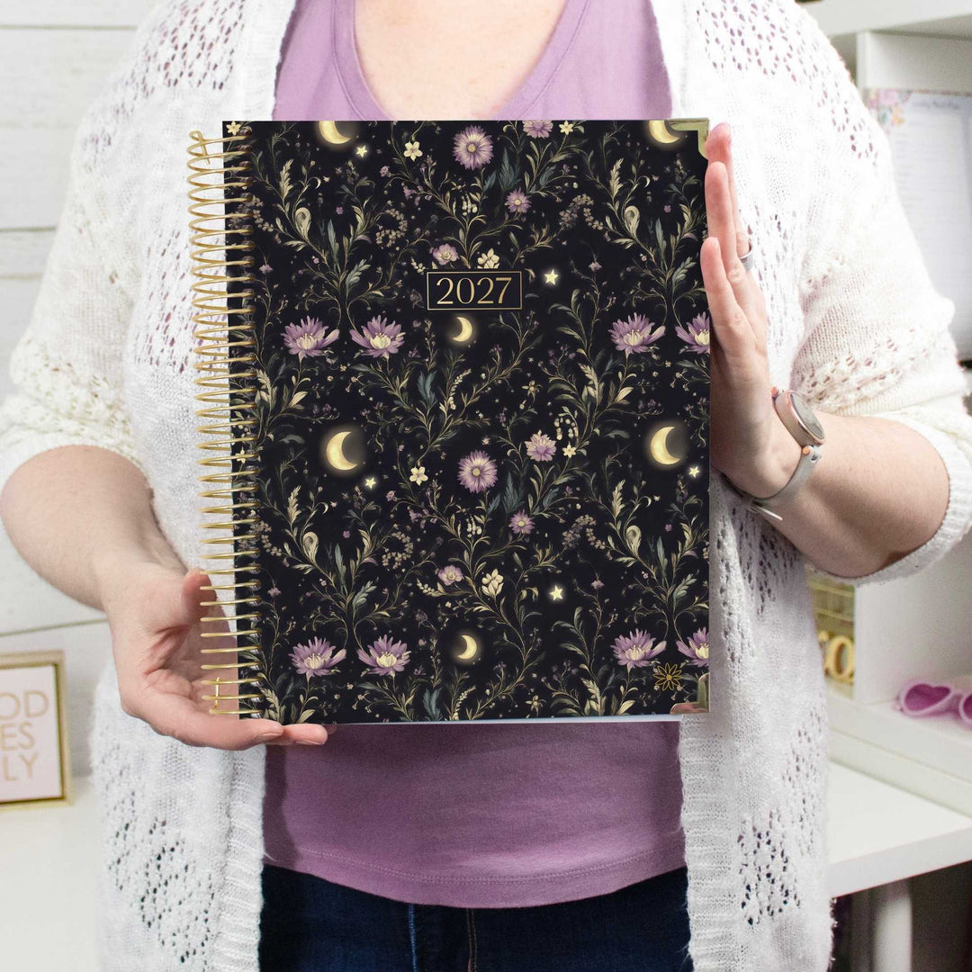 Person holding a 8.5" x 11" Hard Cover Daily Planner in the pattern Moonlit Garden.