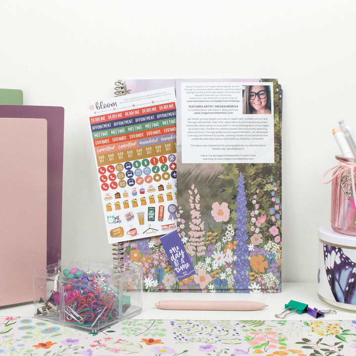 Planner with stickers and stationery on a desk