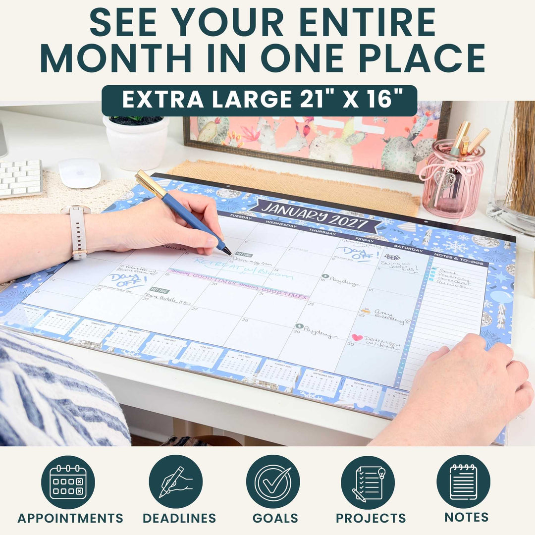 Person using a large desk calendar with text 'See your entire month in one place' and product dimensions.