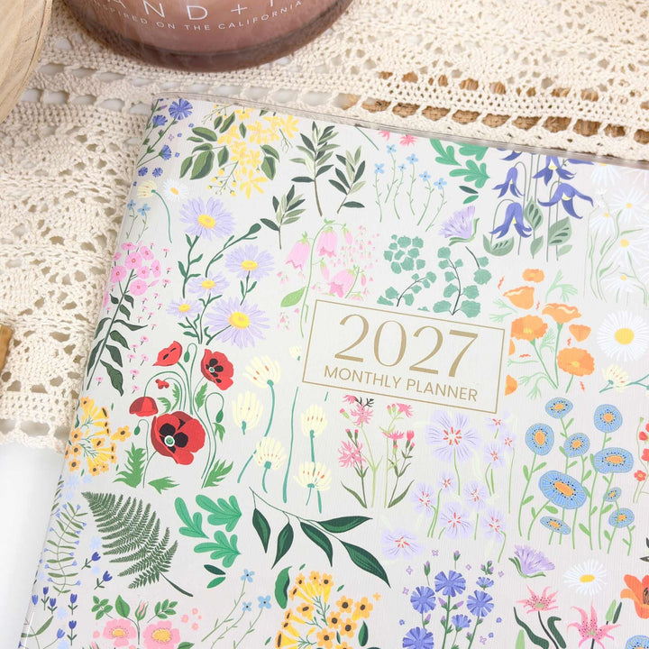 Floral-patterned 2027 monthly planner on a textured surface