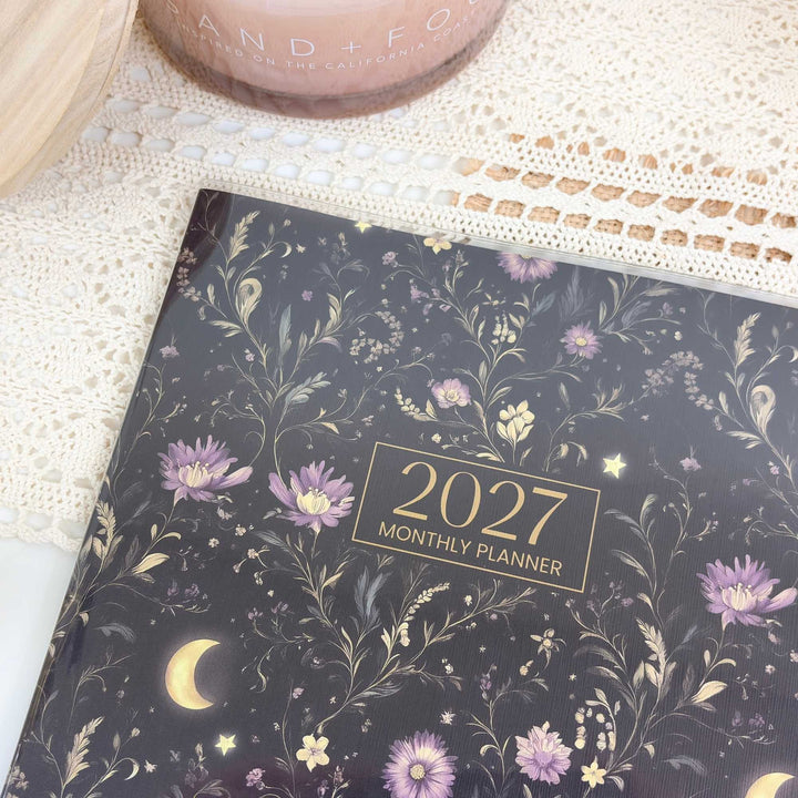 2027 monthly planner with floral design on a textured surface