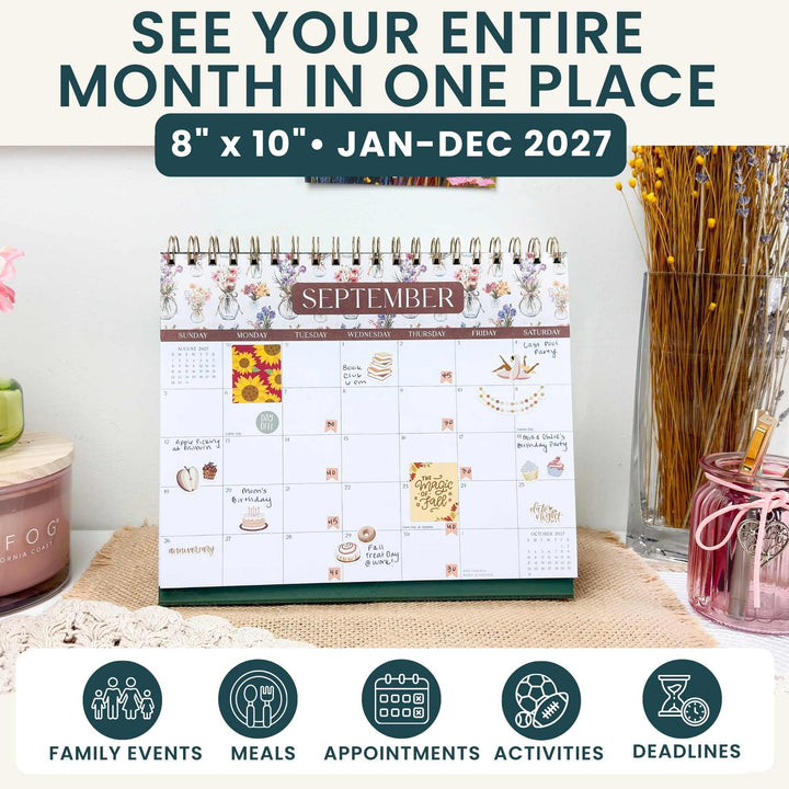 September 2027 bloom calendar page displayed on a home desk with dried botanicals.
