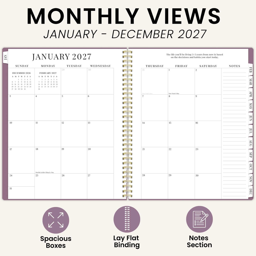 An open planner showing a January 2027 monthly calendar spread with gold spiral binding, on a light beige background. Large text at the top reads 'MONTHLY VIEWS JANUARY - DECEMBER 2027,' and three feature icons at the bottom highlight spacious boxes, lay-flat binding, and a notes section.