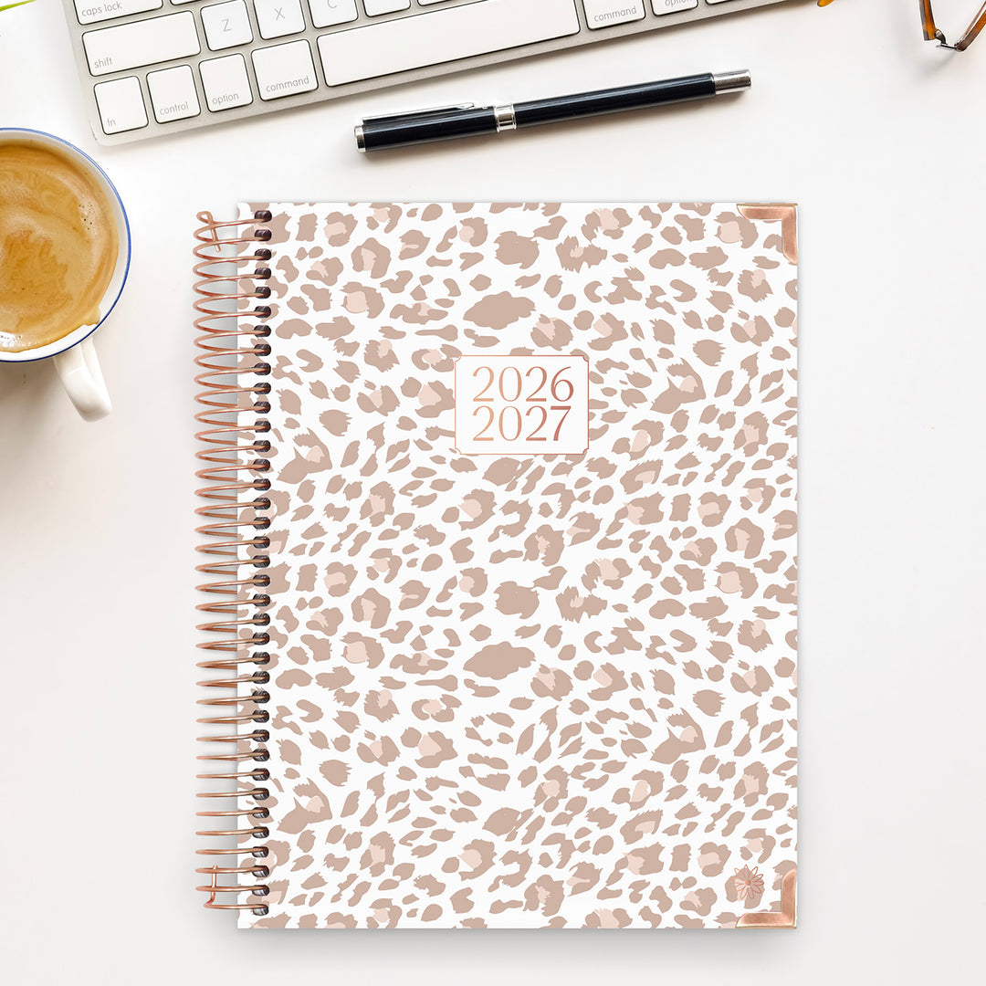 Leopard print planner for 2026-2027 on a desk with a cup of coffee and keyboard.