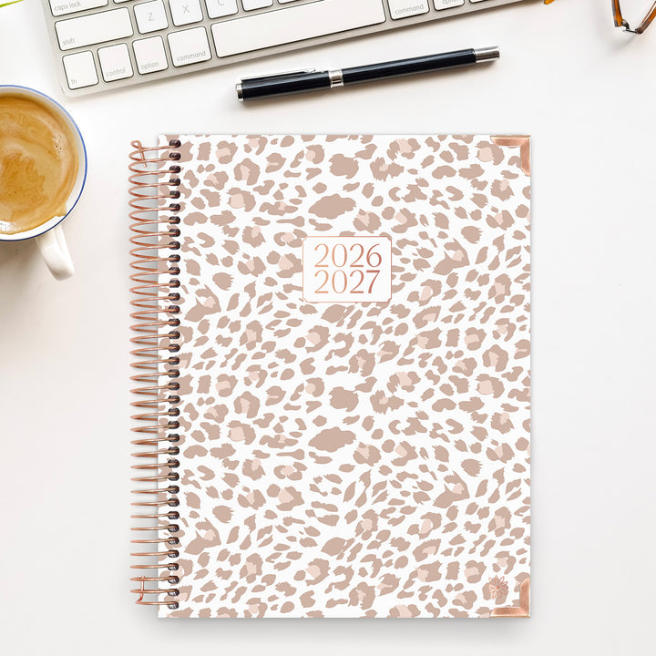 Leopard print planner for 2026-2027 on a desk with a cup of coffee and keyboard.
