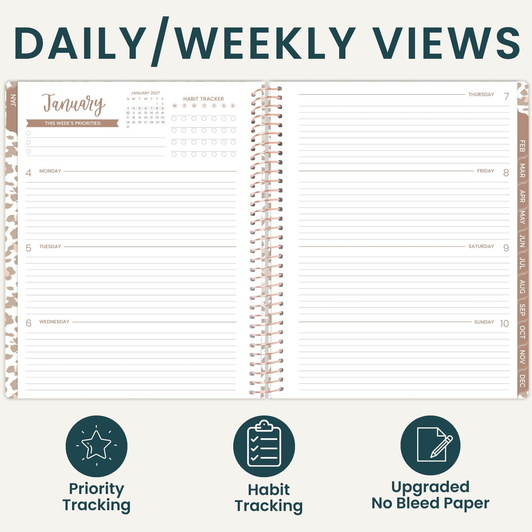 An open spiral-bound planner shown from above, with the heading 'DAILY/WEEKLY VIEWS' across the top and three feature icons below: Priority Tracking, Habit Tracking, and Upgraded No Bleed Paper. The planner pages are white with dark teal text and light tan/beige decorative border accents.