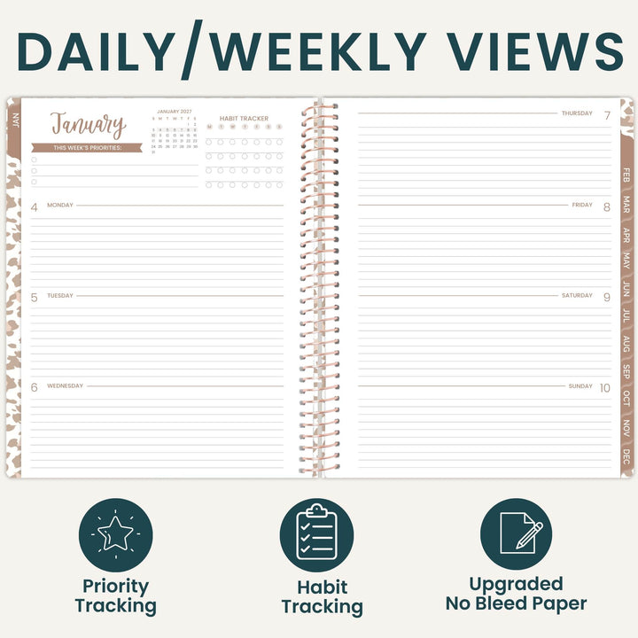 An open spiral-bound planner shown from above, with the heading 'DAILY/WEEKLY VIEWS' across the top and three feature icons below: Priority Tracking, Habit Tracking, and Upgraded No Bleed Paper. The planner pages are white with dark teal text and light tan/beige decorative border accents.