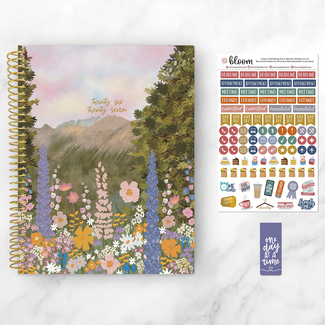 Planner with nature-themed cover and sticker sheet on a white background
