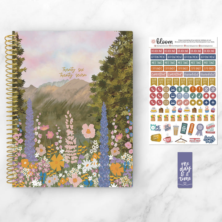 Planner with nature-themed cover and sticker sheet on a white background