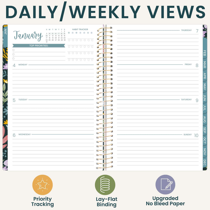 An open spiral-bound planner showing a daily and weekly view layout with lined pages, calendar trackers, and decorative floral page edges. The top reads 'DAILY/WEEKLY VIEWS' and the bottom includes three feature icons and labels: Priority Tracking, Lay-Flat Binding, and Updated Bleed Paper.