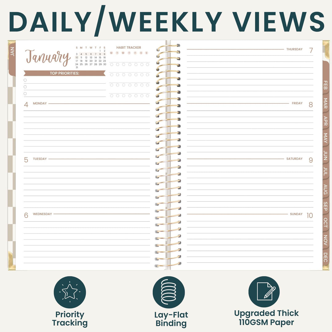 An open spiral-bound planner shown from the inside with daily and weekly view layouts, under the heading 'DAILY/WEEKLY VIEWS.' The planner pages are off-white with dark teal text and lines, plus tan/gold spiral binding and side tabs.