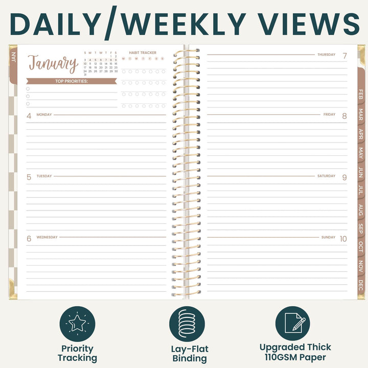 An open spiral-bound planner shown from the inside with daily and weekly view layouts, under the heading 'DAILY/WEEKLY VIEWS.' The planner pages are off-white with dark teal text and lines, plus tan/gold spiral binding and side tabs.