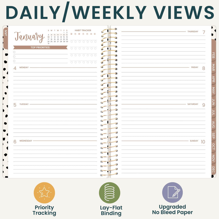 An open spiral-bound planner shown from above, with the heading 'DAILY/WEEKLY VIEWS' across the top and feature icons and text along the bottom. The planner pages are white with dark teal headers, gold spiral binding, and tan/brown weekly sections.