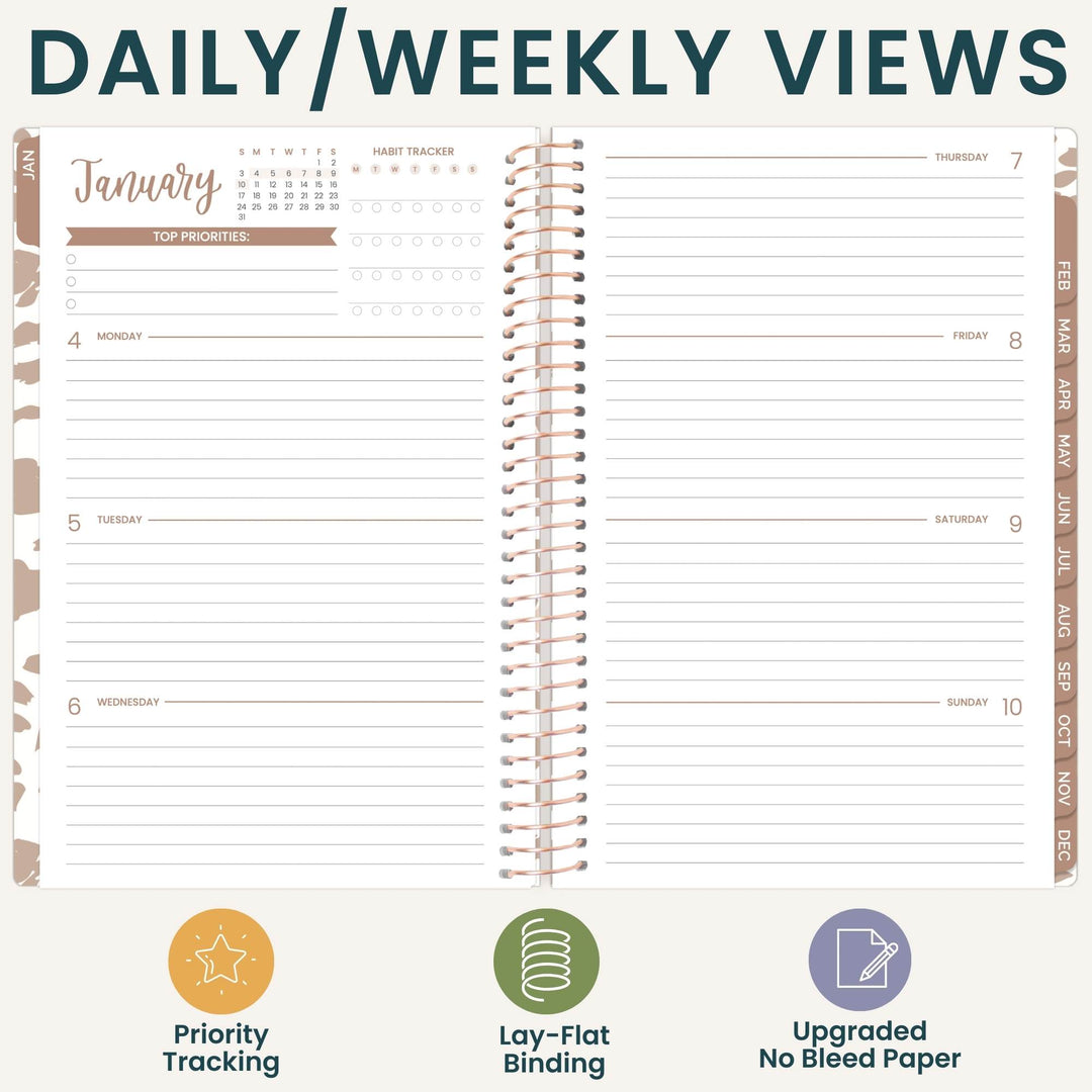 An open spiral-bound planner shown on a light beige background with the heading 'DAILY/WEEKLY VIEWS' at the top. The planner page includes sections for Monday through Sunday, a January calendar, habit tracker boxes, and vertical tabs labeled by month.