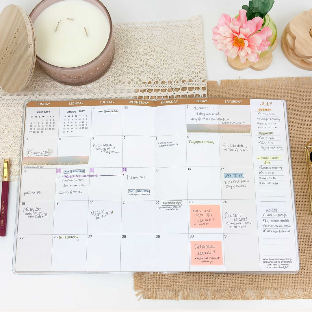 Calendar planner on a table with a candle and flower decoration