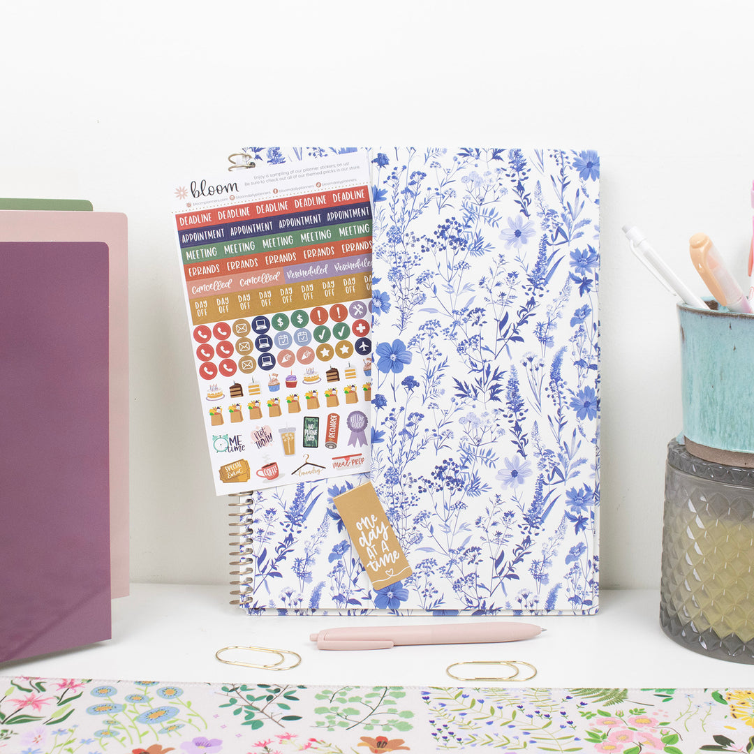 Floral planner with stickers on a desk with stationery items