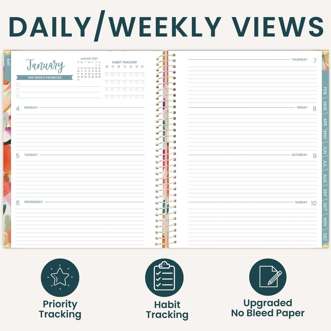 An open planner shown from above with the heading 'DAILY/WEEKLY VIEWS' at the top and three feature icons below: priority tracking, habit tracking, and upgraded no bleed paper. The planner pages are mostly white with teal and multicolor printed sections and a spiral binding.