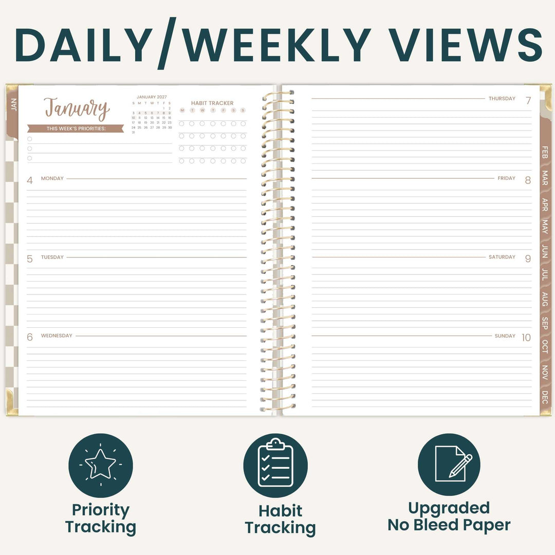 An open spiral-bound planner shown from the front with a daily and weekly view layout, titled 'DAILY/WEEKLY VIEWS.' The planner has lined pages, date columns, weekday sections, and tracking areas for priorities and habits.