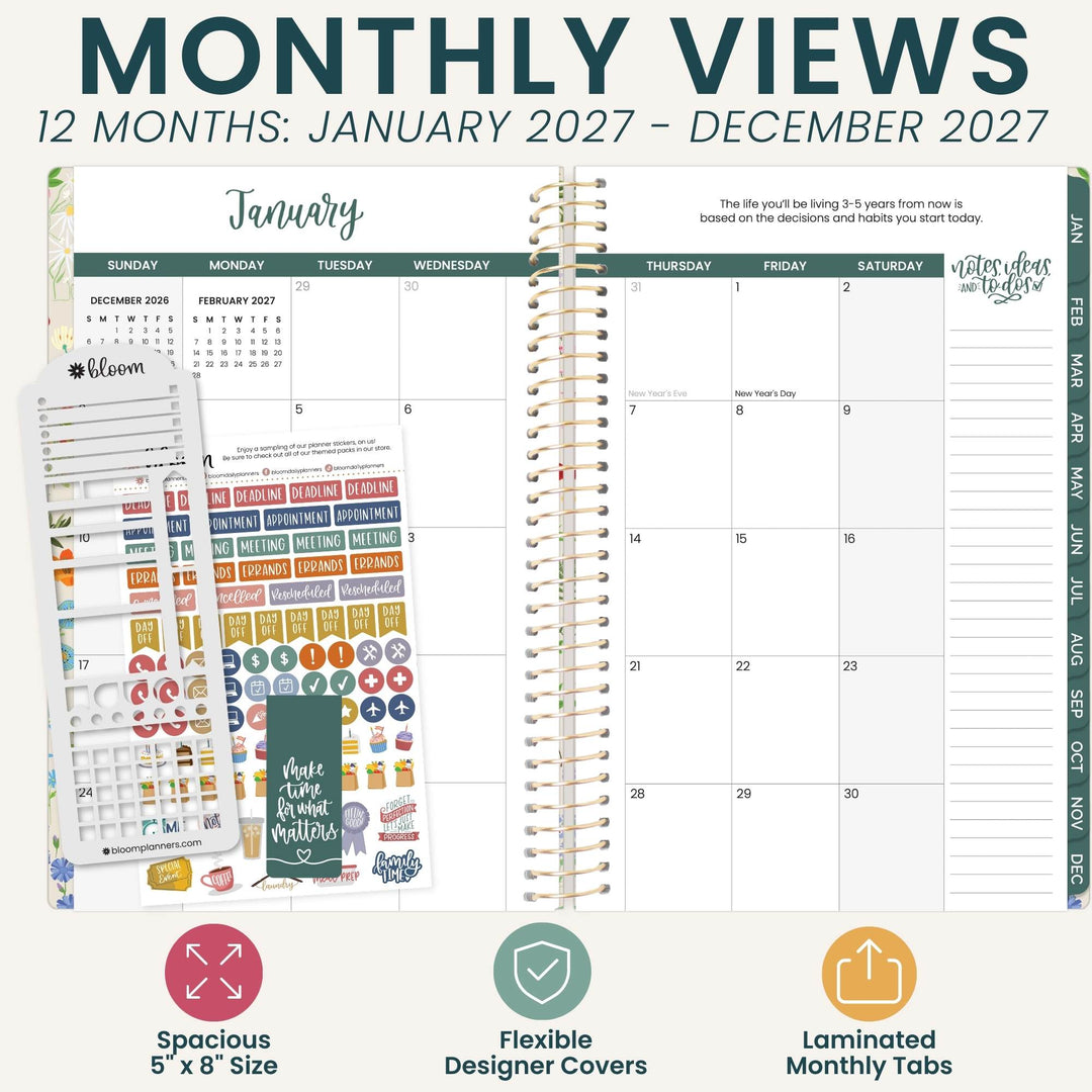 A planner product mockup showing a spiral-bound monthly view planner page with decorative planner stickers and a sheet of colorful labels. Large text at the top reads 'MONTHLY VIEWS 12 MONTHS: JANUARY 2027 - DECEMBER 2027' and feature callouts at the bottom mention spacious 5 x 8 size, flexible designer covers, and laminated monthly tabs.