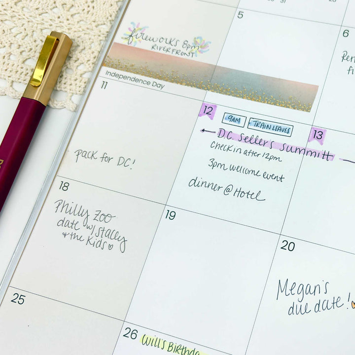 Calendar with hand-written notes and a pen on a textured surface