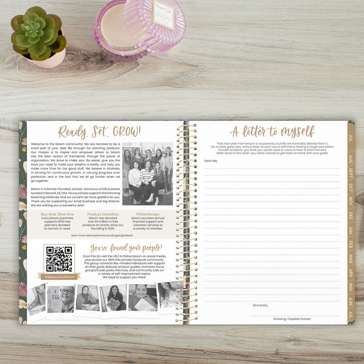 Open spiral-bound planner on a wooden surface with text and images.