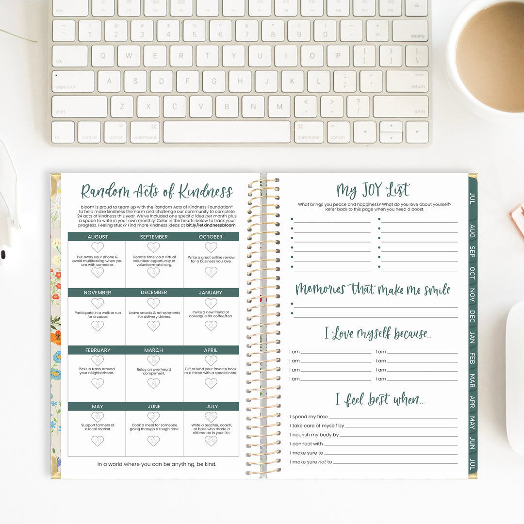 Kindness Challenge and Joy List Tracker in an open planner spread on a desk.