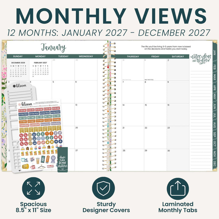 An open spiral-bound planner shown on a light beige background with marketing text reading 'MONTHLY VIEWS' and feature callouts. The planner pages are mostly white with dark teal headers and a multicolor sticker sheet attached on the left.