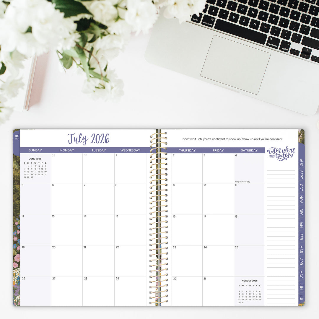 Open planner showing July 2026 with a laptop and flowers in the background