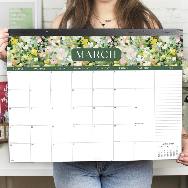 Person holding a floral March calendar