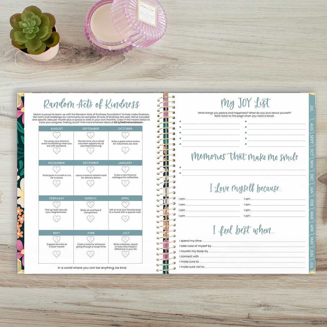 Random acts of kindness challenge and joy list tracker in an open planner spread.