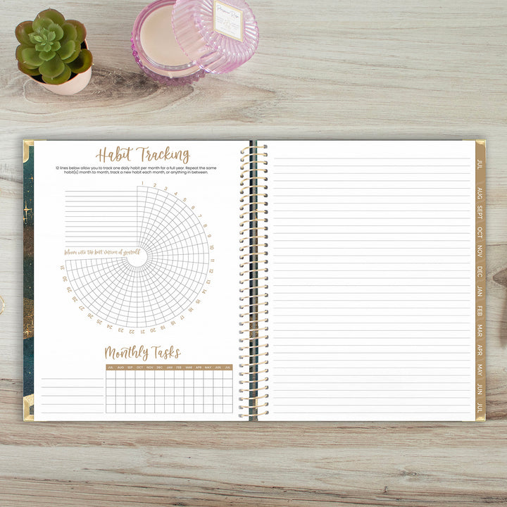 Open planner with habit tracking and monthly tasks sections on a wooden surface.