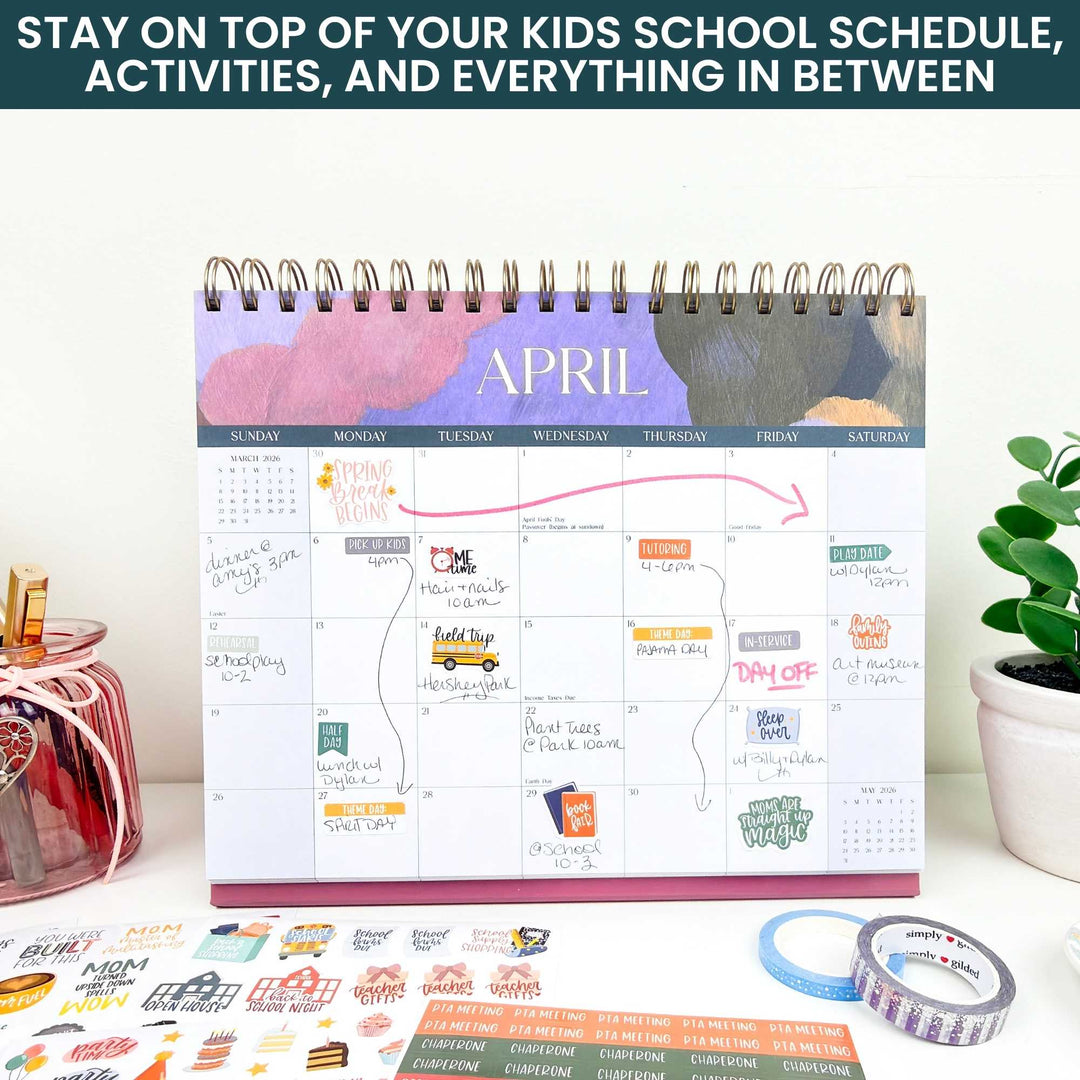 Monthly planner with a calendar for April on a desk with stationery items.