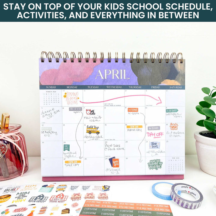 Monthly planner with a calendar for April on a desk with stationery items.