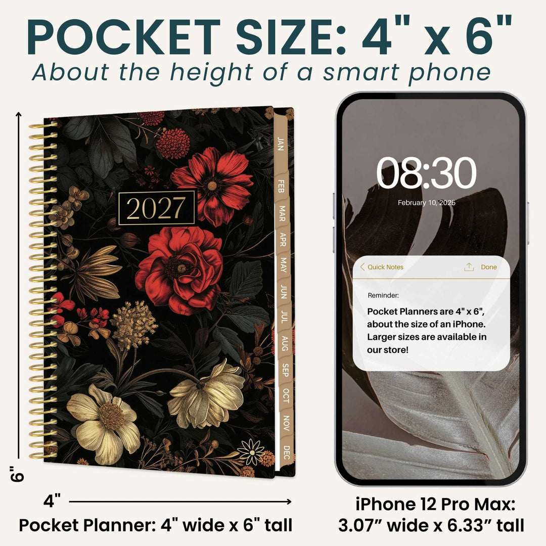 A pocket size 2027 floral planner shown next to an iPhone for size comparison. The planner features a black cover decorated with red and cream flowers, gold floral details, and a gold vertical spine.
