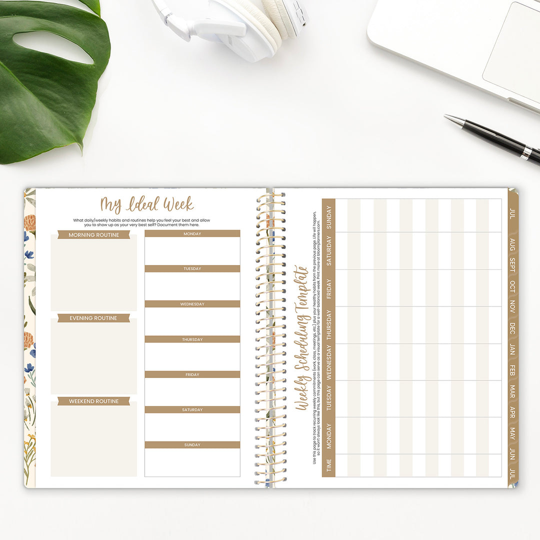 Open planner with weekly schedule on a white surface with a plant and pen.
