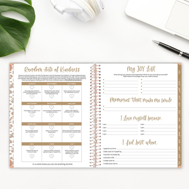 Random Acts of Kindness Page and Joy List Page in a planner spread on a desk. 