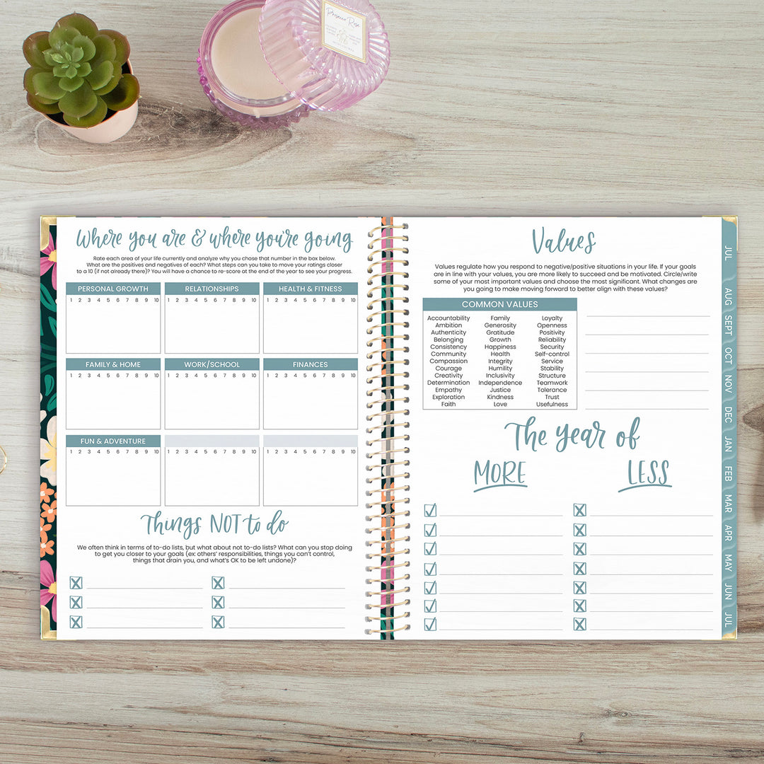 Open planner on a wooden surface with decorative items