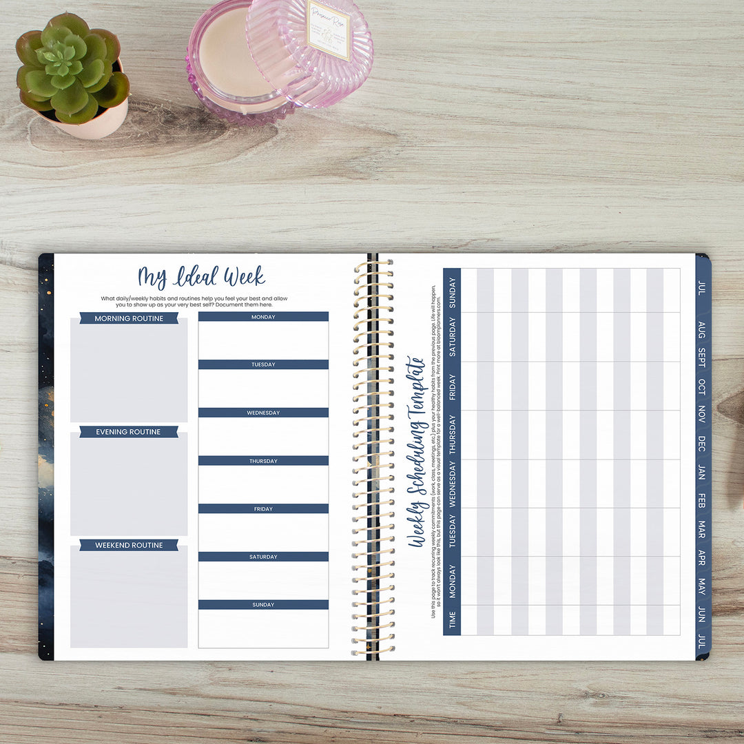 Open weekly planner on a wooden surface with a small plant and candle in the background