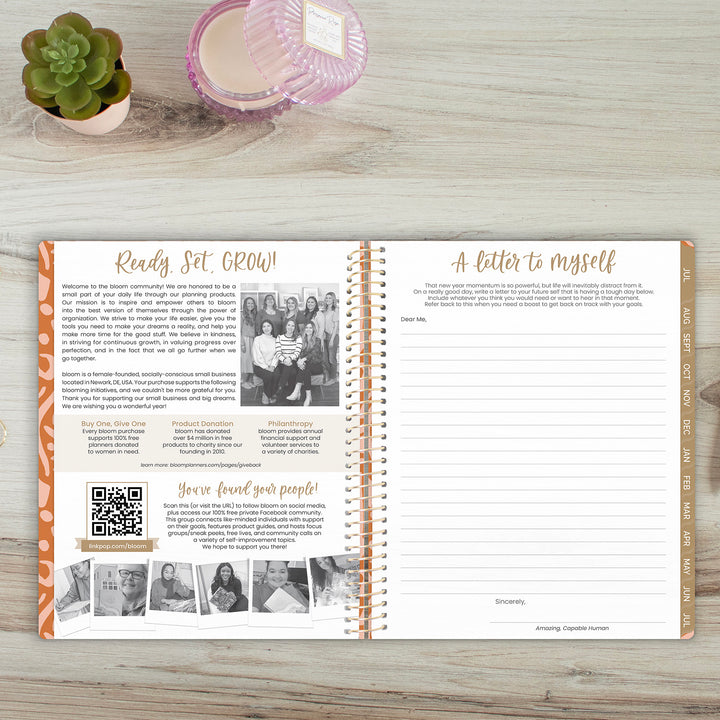 Open planner on a wooden surface with text and images